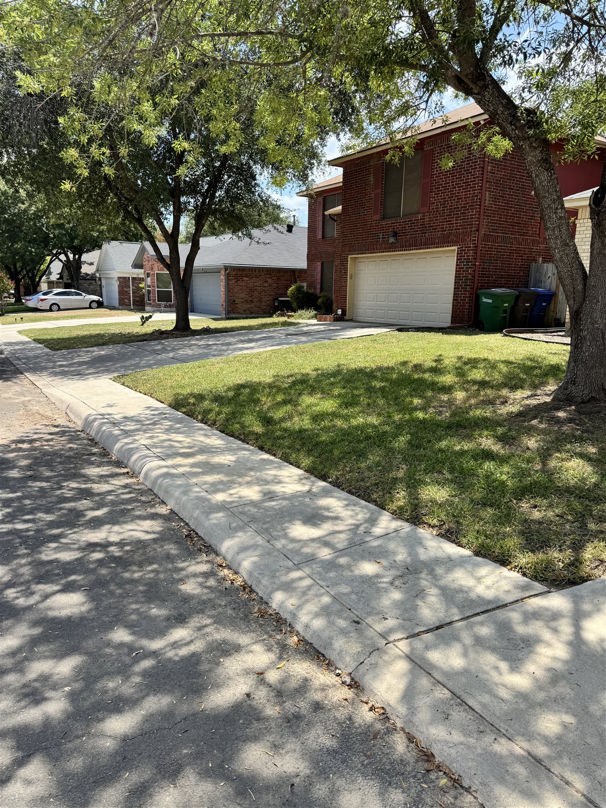 Sidewalk & Curb Line after pressure washing in San Antonio
